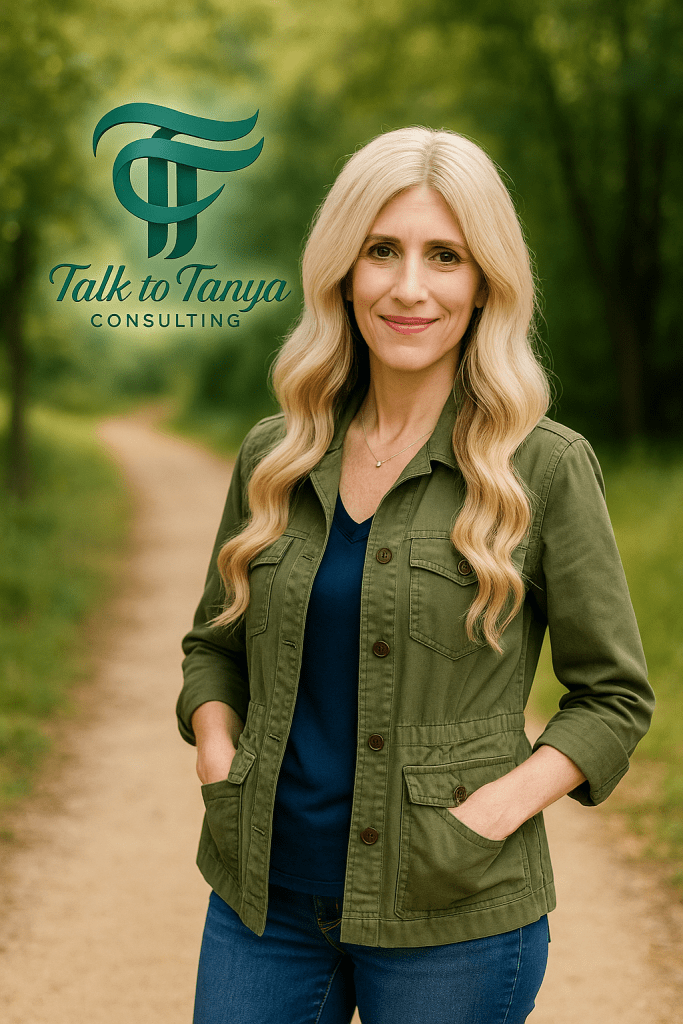Tanya outdoors in green jacket, logo blurred in background