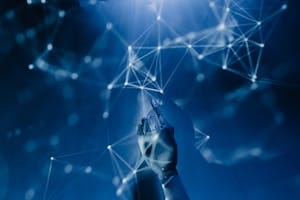 How To Use AI For Service-Based Businesses Without Tech Overwhelm 3 A robotic hand reaching into a digital network on a blue background, symbolizing AI technology.